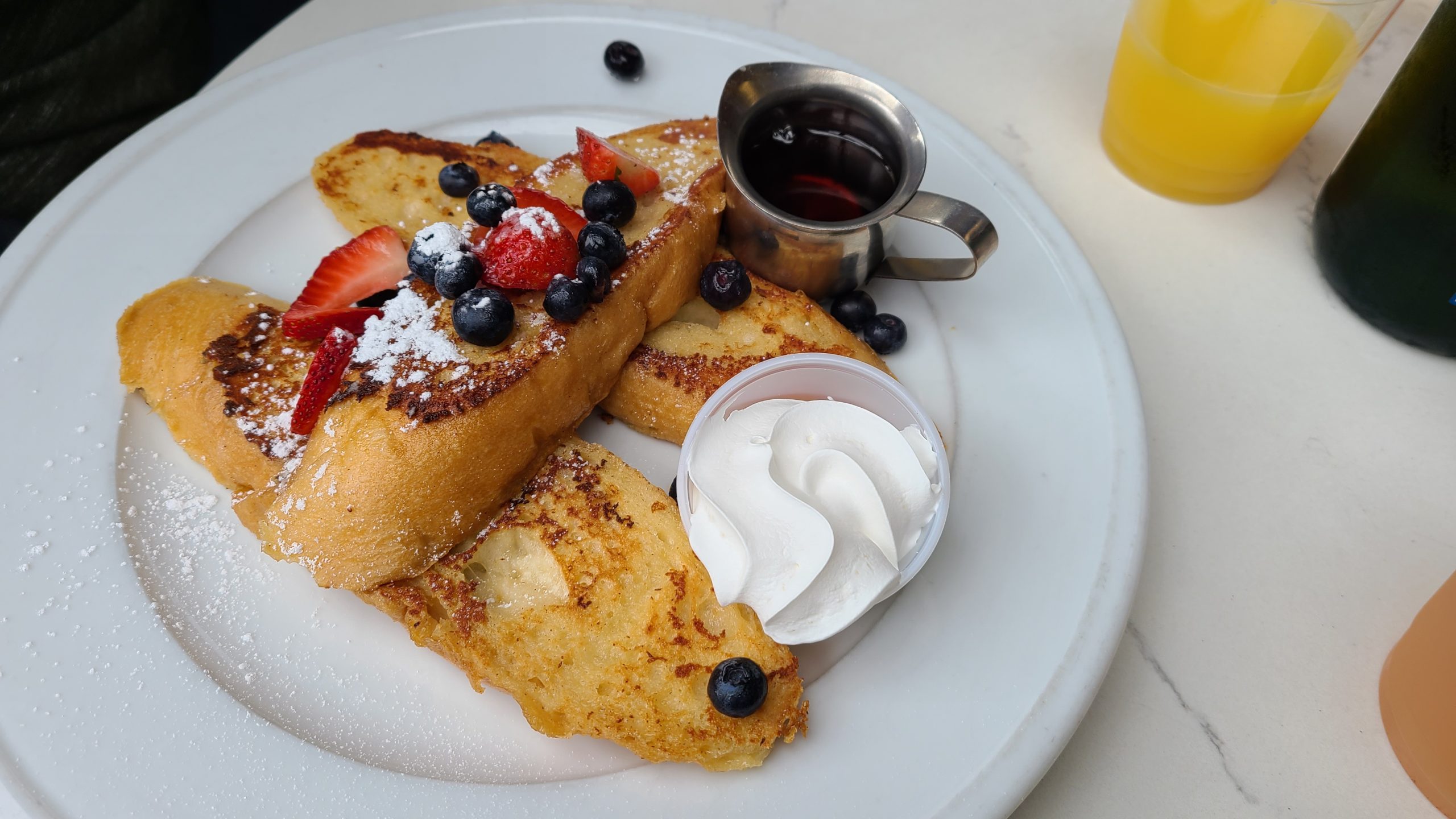French Toast with berries, syrup, and whipped cream